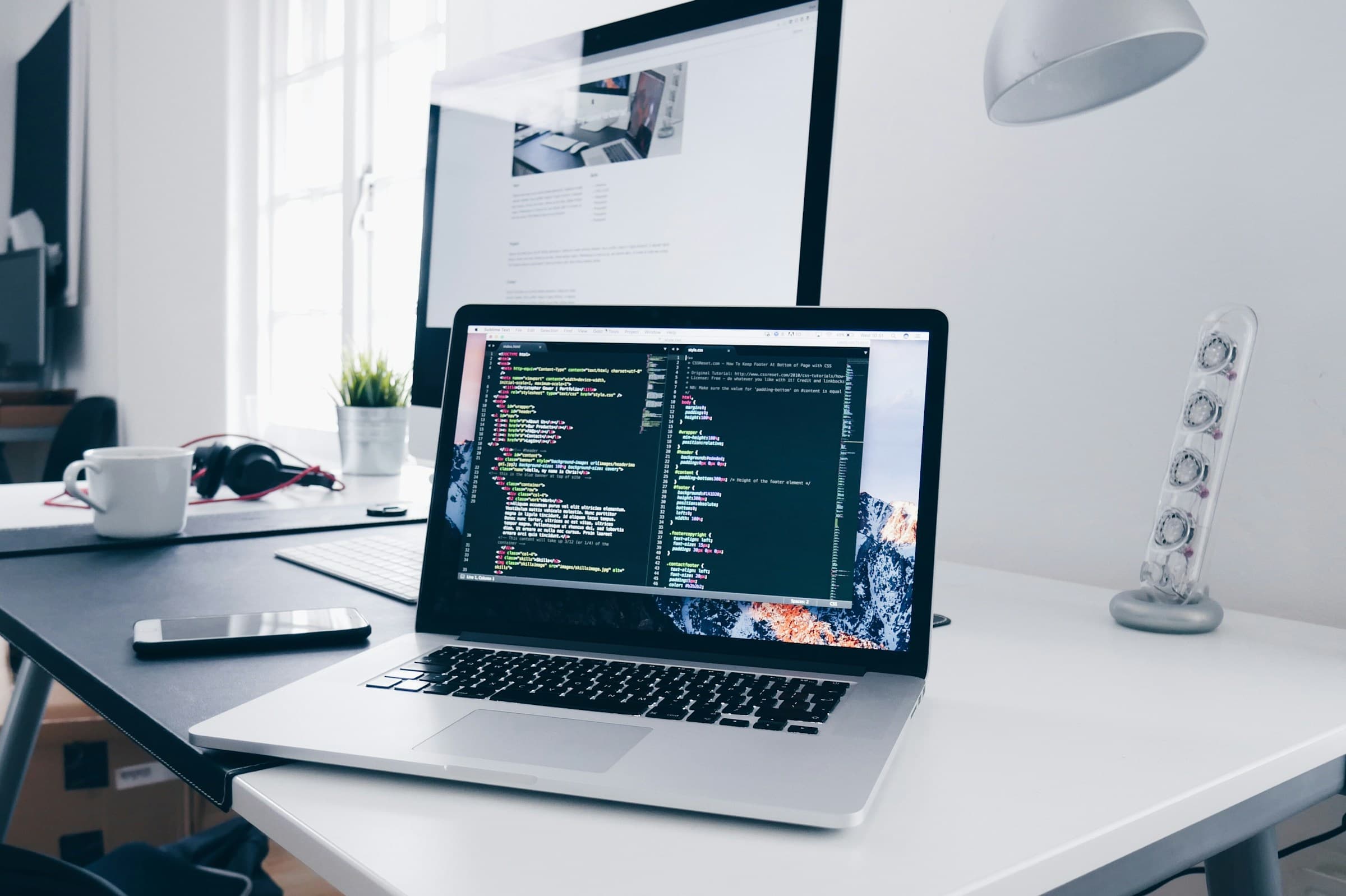 Code on a laptop screen on a working desk